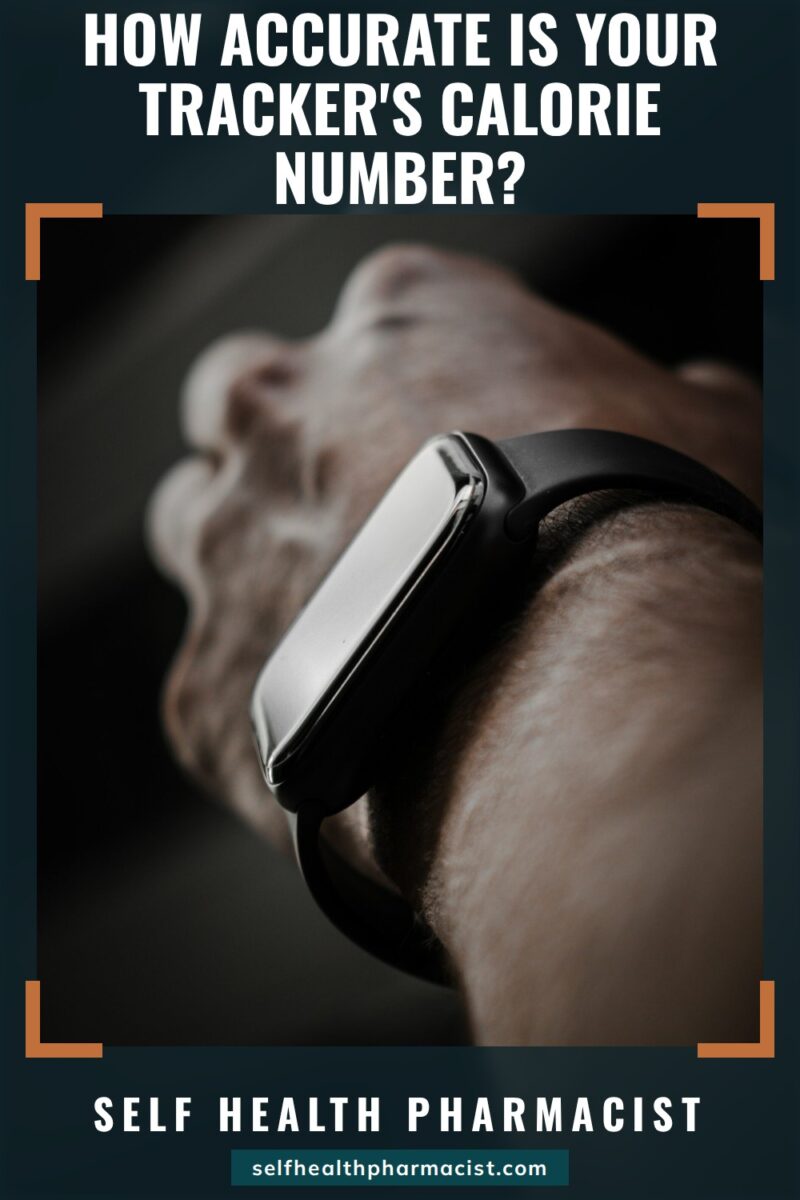 How Accurate Is Your Tracker's Calorie Number?: Close-up of a wrist wearing a black fitness watch with a dark screen against a dark background